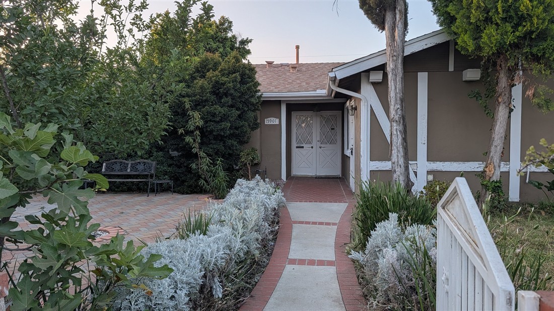 Garden path leading to the entrance of the Elaris home